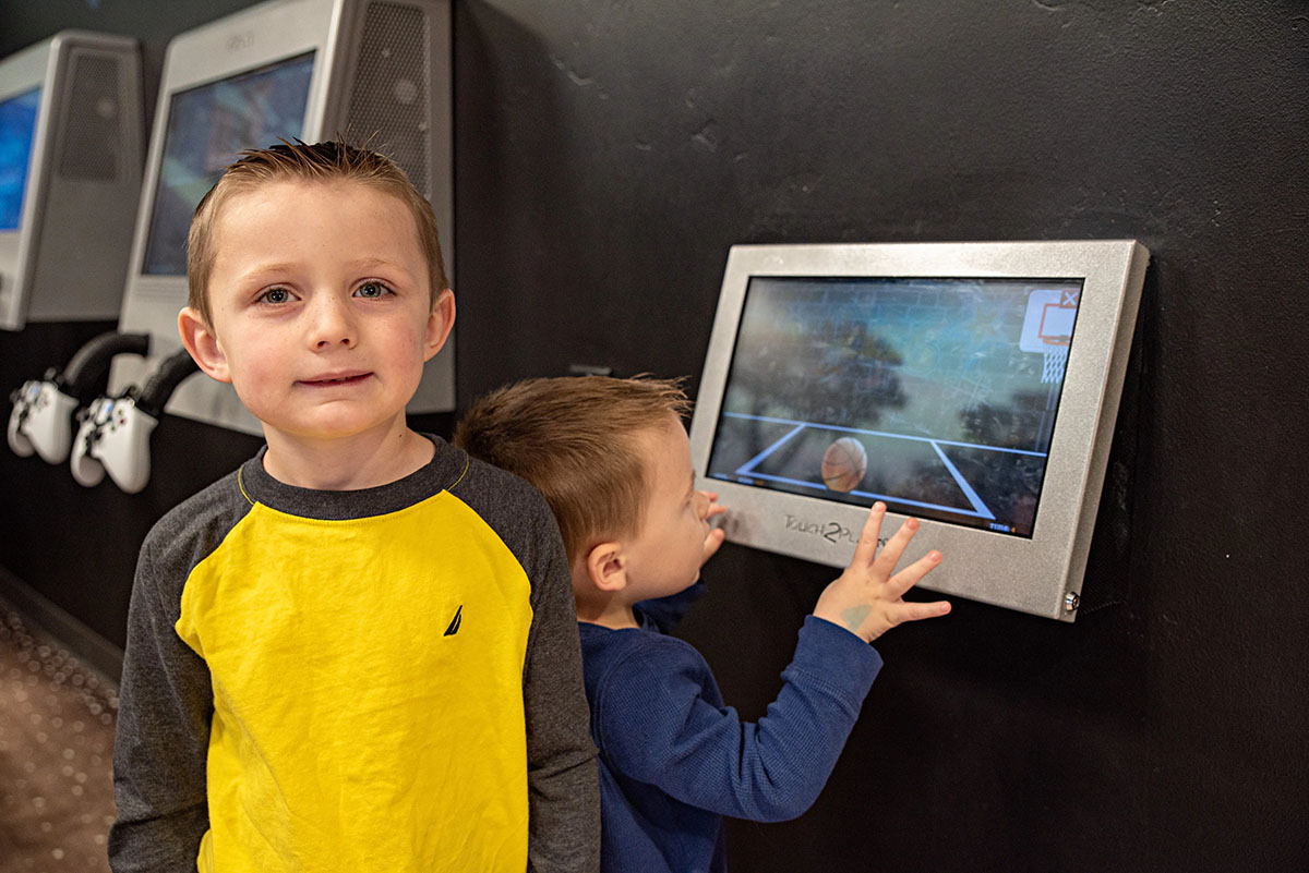 Children playing on the game wall at Utah Children's Dentistry